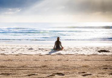 WORK Mindful Moments woman on beach meditating